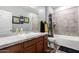 Bathroom featuring a vanity with tub and shower featuring decorative shower curtain at 24027 N 164Th Dr, Surprise, AZ 85387