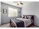 Bedroom featuring a decorative bed, ceiling fan, and window with blinds at 24027 N 164Th Dr, Surprise, AZ 85387