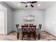 Well-lit dining room with beach scene, wood-look flooring, and wooden table set for a stylish dining experience at 24027 N 164Th Dr, Surprise, AZ 85387