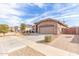 Charming single-story home with well-maintained desert landscaping and a two-car garage on a sunny day at 24027 N 164Th Dr, Surprise, AZ 85387