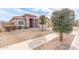 Attractive single-story home featuring desert landscaping and a covered entrance way on a sunny day at 24027 N 164Th Dr, Surprise, AZ 85387