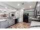 Modern kitchen featuring gray cabinets, stainless steel appliances, and stylish backsplash, and an open floor plan at 24027 N 164Th Dr, Surprise, AZ 85387