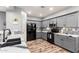 Modern kitchen featuring gray cabinets, stainless steel appliances, and stylish backsplash, ready for your cooking adventures at 24027 N 164Th Dr, Surprise, AZ 85387