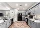 Modern kitchen featuring sleek gray cabinets, stainless steel appliances, and stylish backsplash, for a chic cooking space at 24027 N 164Th Dr, Surprise, AZ 85387