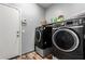 Laundry room with modern black washer and dryer set with a door leading outside at 24027 N 164Th Dr, Surprise, AZ 85387