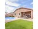 Backyard showcasing a private pool, covered patio, green grass, and seating area at 24027 N 164Th Dr, Surprise, AZ 85387