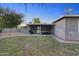 Spacious backyard featuring a covered patio, barbecue, and a well-maintained lawn at 2709 E Clarendon Ave, Phoenix, AZ 85016