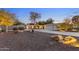 Beautiful house at dusk with landscaped rock yard and long driveway to three-car garage at 2709 E Clarendon Ave, Phoenix, AZ 85016