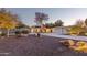 Stunning shot of a landscaped home, featuring a wide driveway and a well-lit three-car garage at 2709 E Clarendon Ave, Phoenix, AZ 85016