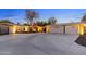 Beautiful property with a long driveway leading to a three-car garage, surrounded by desert landscaping at 2709 E Clarendon Ave, Phoenix, AZ 85016