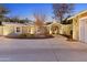 Home exterior showcasing a well-lit front yard with a circular driveway leading to a covered entryway at 2709 E Clarendon Ave, Phoenix, AZ 85016