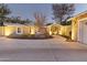 Home exterior showcasing a well-lit front yard with a circular driveway leading to a covered entryway at 2709 E Clarendon Ave, Phoenix, AZ 85016