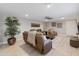 Inviting living room featuring leather seating, decorative wall art, and a stylish ceiling fan at 2709 E Clarendon Ave, Phoenix, AZ 85016