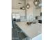 Close up view of kitchen island featuring white countertops, a stainless steel sink, and pendant lighting at 27411 N 256Th Dr, Wittmann, AZ 85361