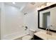 Bright bathroom featuring a shower/tub combination and a large mirror above the sink at 2959 N 68Th Pl # 112, Scottsdale, AZ 85251