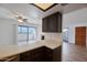 Bright kitchen featuring granite counters, dark wood cabinets, and sliding glass doors to the patio at 2959 N 68Th Pl # 112, Scottsdale, AZ 85251