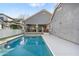 Inviting backyard pool and patio with a grassy area and grey-toned house at 3006 E Agritopia N Loop, Gilbert, AZ 85296