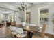 Bright dining room featuring a wooden table, stylish chairs, and views from multiple windows at 3006 E Agritopia N Loop, Gilbert, AZ 85296