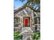 Charming home featuring a red front door, stone accents, and lush green lawn at 3006 E Agritopia N Loop, Gilbert, AZ 85296