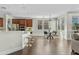 Open-concept kitchen with dark wood floors, white countertops, stainless steel appliances, and an adjacent dining area at 3006 E Agritopia N Loop, Gilbert, AZ 85296