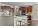 Open kitchen featuring dark wood cabinets, a breakfast bar, and stainless steel appliances at 3006 E Agritopia N Loop, Gilbert, AZ 85296