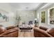 Cozy living room featuring natural light, hardwood floors and comfortable seating at 3006 E Agritopia N Loop, Gilbert, AZ 85296