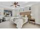 Calm bedroom featuring neutral decor, a ceiling fan, and large window allowing for ample natural light at 3006 E Agritopia N Loop, Gilbert, AZ 85296