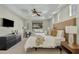 Cozy bedroom with a neutral color scheme, plush bedding, ceiling fan, and a flat screen TV at 3006 E Agritopia N Loop, Gilbert, AZ 85296