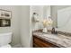 Elegant powder room featuring granite countertop and a decorative vase, enhanced by stylish framed art at 3006 E Agritopia N Loop, Gilbert, AZ 85296