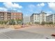 Street view of the modern apartment buildings on a sunny day with blue skies and greenery at 3006 E Agritopia N Loop, Gilbert, AZ 85296