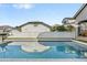 Sparkling swimming pool reflects a charming backyard and blue skies at 3006 E Agritopia N Loop, Gilbert, AZ 85296