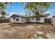 Spacious backyard featuring a detached garage and mature shade trees at 3322 E Willetta St, Phoenix, AZ 85008