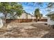 Backyard featuring a detached garage, a patio, mature trees, and a wooden fence at 3322 E Willetta St, Phoenix, AZ 85008