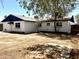 Spacious backyard with a covered patio area, mature trees, and a mix of open space perfect for outdoor activities at 3322 E Willetta St, Phoenix, AZ 85008