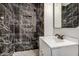 Modern bathroom featuring a vanity, mirror, and tiled shower with sleek fixtures at 3322 E Willetta St, Phoenix, AZ 85008