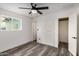 Lovely bedroom featuring a ceiling fan, closet, and wood look flooring at 3322 E Willetta St, Phoenix, AZ 85008