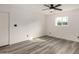 Spacious bedroom featuring a ceiling fan, natural light, and updated flooring at 3322 E Willetta St, Phoenix, AZ 85008