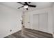 Bedroom featuring wood-look flooring, a ceiling fan, closet, and interior door leading to another room at 3322 E Willetta St, Phoenix, AZ 85008