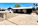 Charming single-story home featuring a well-manicured lawn, large driveway, and a welcoming covered porch at 3322 E Willetta St, Phoenix, AZ 85008
