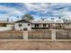 Charming home featuring an iron fence, desert landscaping, and a covered front porch at 3322 E Willetta St, Phoenix, AZ 85008