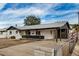 Charming single-story home featuring a covered carport and a well-maintained front yard with mature landscaping at 3322 E Willetta St, Phoenix, AZ 85008