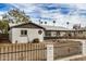 Cozy single-Gathering home featuring a fenced front yard and desert-friendly landscaping, offering privacy and charm at 3322 E Willetta St, Phoenix, AZ 85008