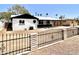 Charming single-story home featuring a black metal fence, desert landscaping, and a inviting covered porch at 3322 E Willetta St, Phoenix, AZ 85008