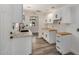 Well-lit kitchen featuring white cabinets, stainless steel appliances, and modern countertops at 3322 E Willetta St, Phoenix, AZ 85008