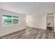 Bright living room with fresh paint, recessed lighting, large window, and plank flooring at 3322 E Willetta St, Phoenix, AZ 85008