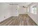 Large living room with plank floors, fresh white paint, and ceiling fan with lighting at 3322 E Willetta St, Phoenix, AZ 85008