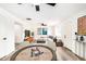 Open-concept living space featuring a poker table, living room, modern furniture, and neutral decor at 3322 E Willetta St, Phoenix, AZ 85008