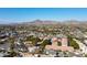 Panoramic aerial view of a sprawling neighborhood with mountain views, showcasing a mix of residential homes and lush landscapes at 3511 E Elm St, Phoenix, AZ 85018