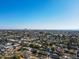 Wide aerial view of residential area with desert and mountains, showcasing the tree-lined streets and homes with pool at 3511 E Elm St, Phoenix, AZ 85018