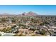 Scenic aerial view of a residential area near a mountain, showcasing tree-lined streets and a mix of homes and landscapes at 3511 E Elm St, Phoenix, AZ 85018